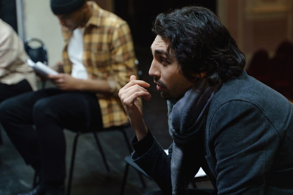 Actor at a desk working through self assessment paperwork between rehearsals