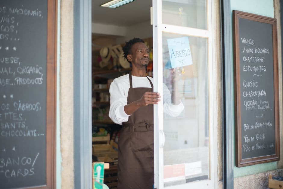 Owner of a small franchised service unit reviewing figures at a desk