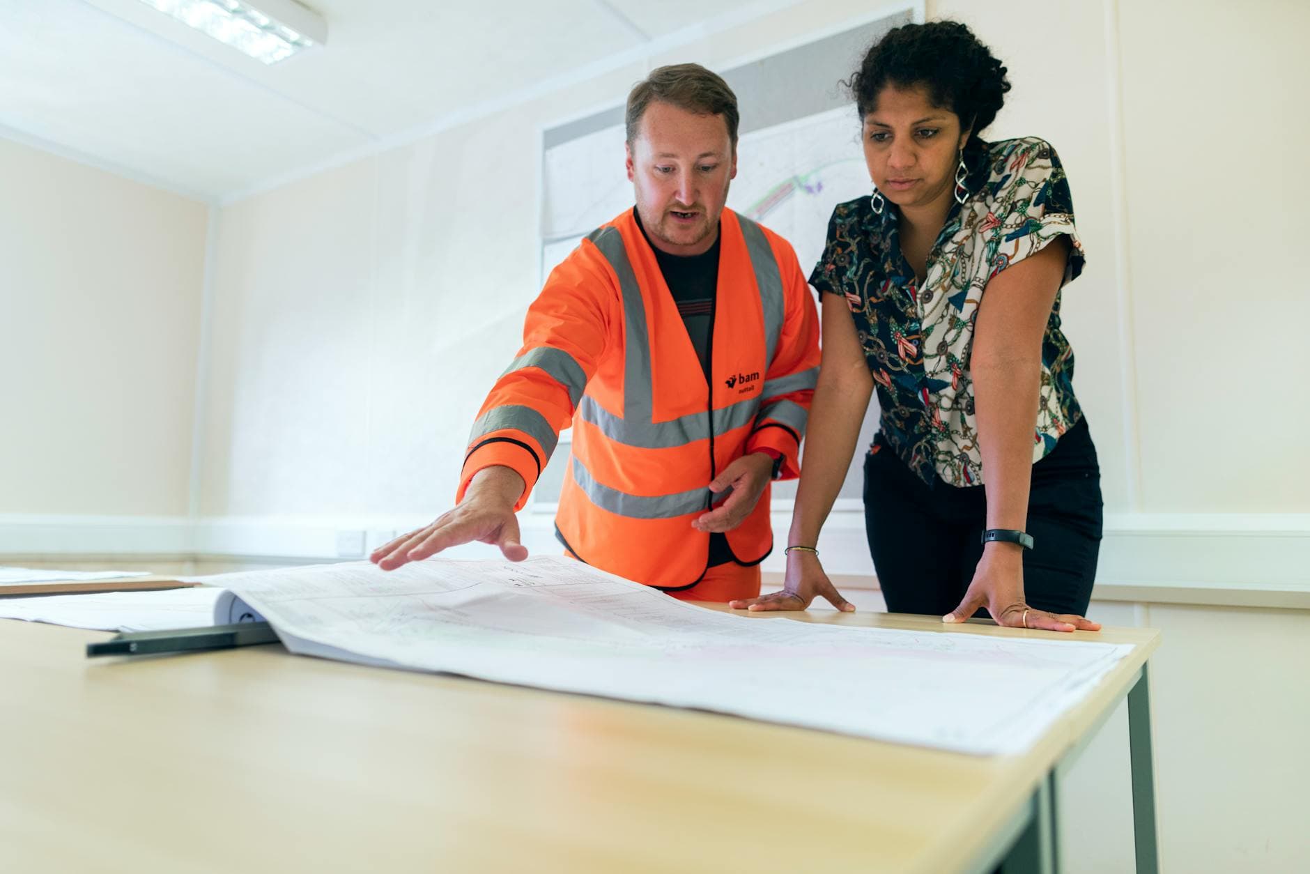 Professional contractor reviewing payslip with umbrella company deductions at modern UK office desk
