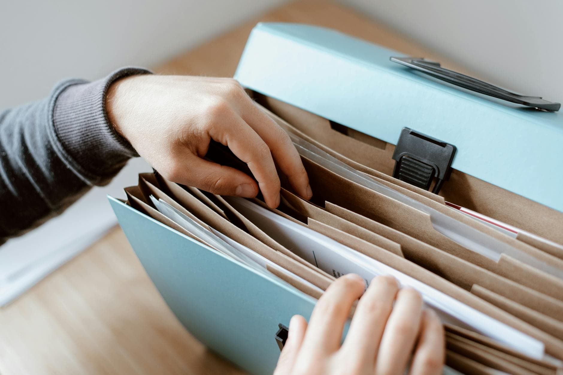 Two business owners reviewing financial reports with their ICAEW-qualified accountant in a modern Manchester office