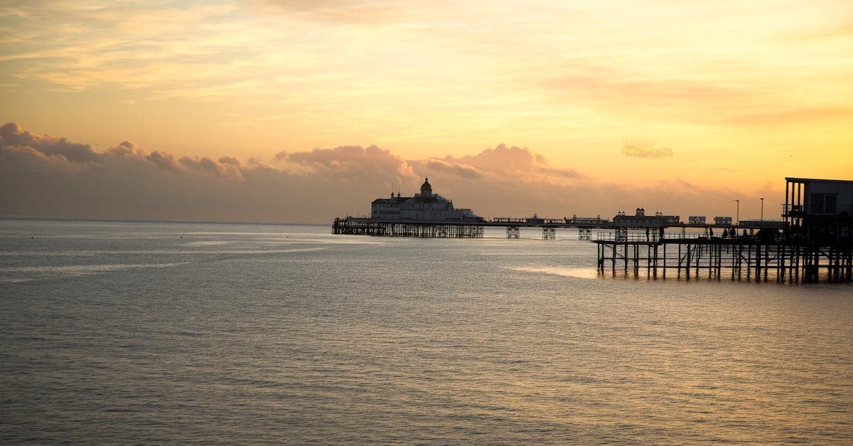 Sunset over Eastbourne Pier with a serene sea view in Eastbourne, England.