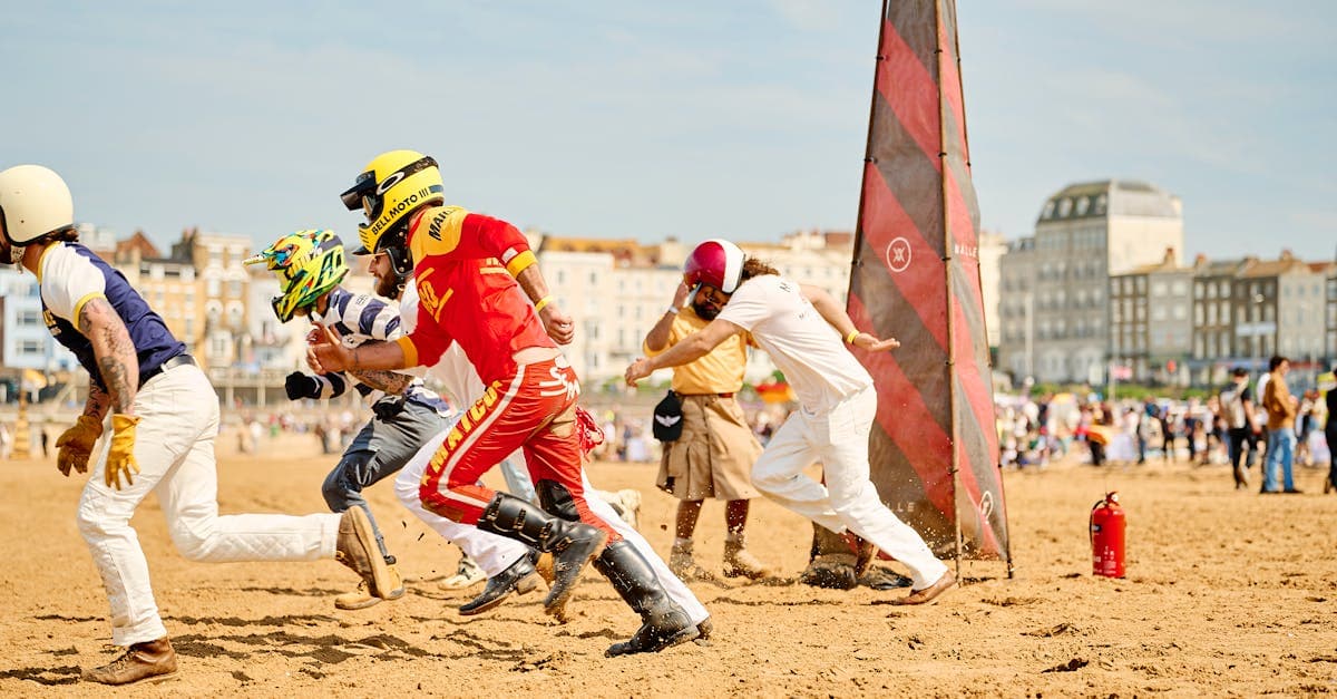 Thrilling motorcycle beach race on a sunny day in Margate, England, featuring riders in action.