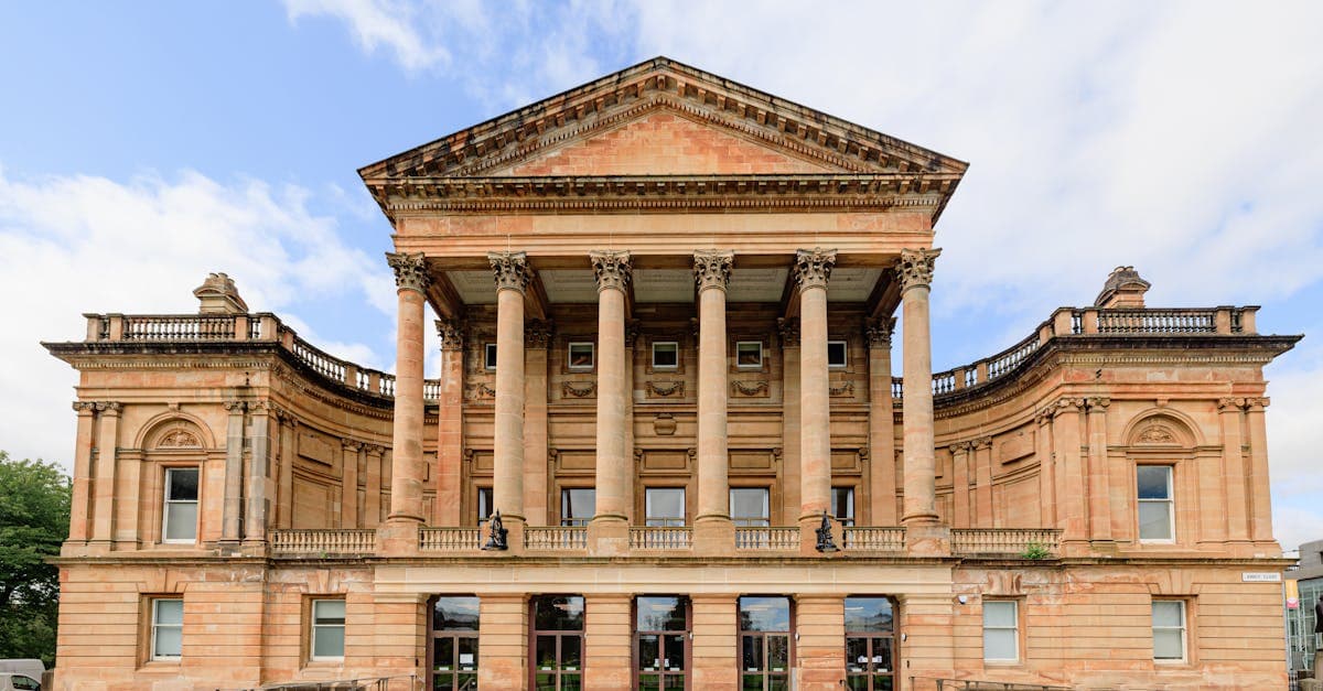 Front view of the neoclassical Paisley Town Hall in Scotland with clear blue skies.
