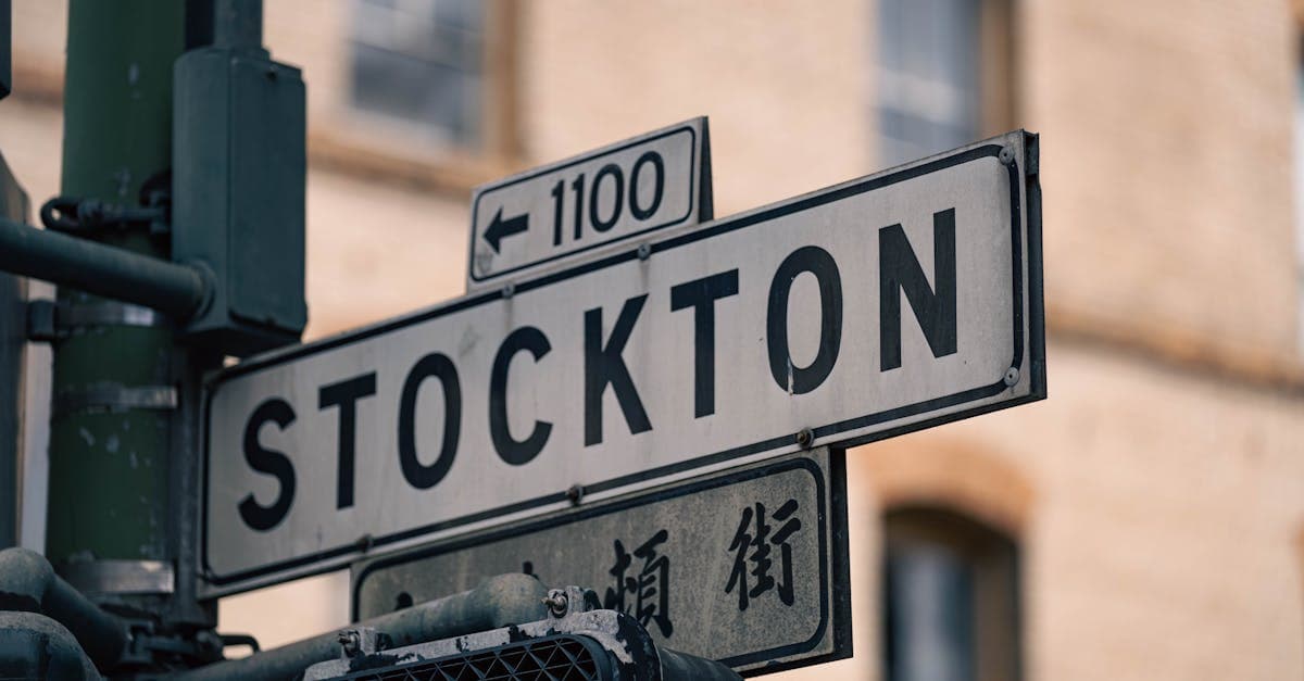 Street sign in Stockton with directional arrows, shot at an intersection, capturing city life.