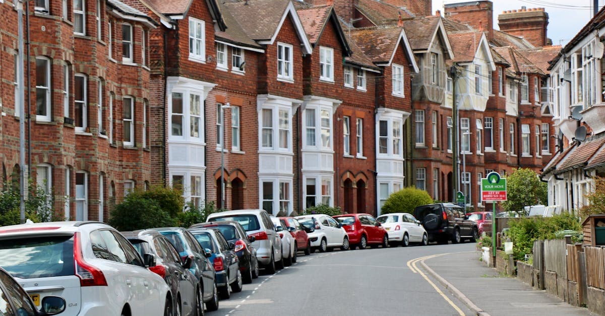 Victorian-style houses and parked cars on a curved street in Royal Tunbridge Wells, UK.