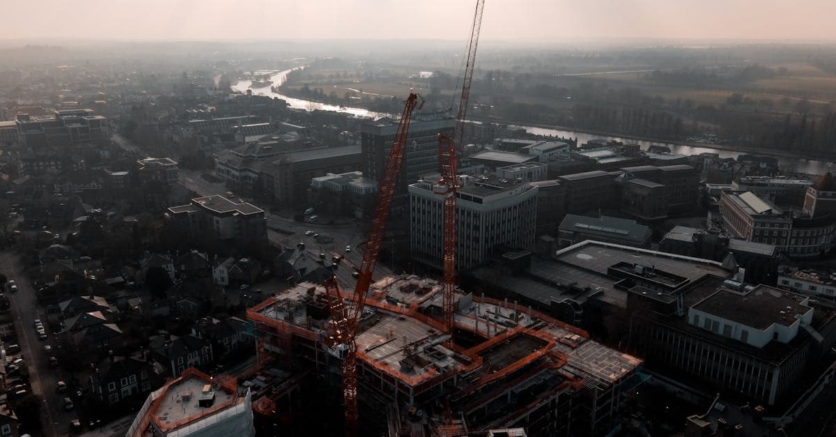 Aerial shot of construction cranes and buildings in Kingston upon Thames, England at day.