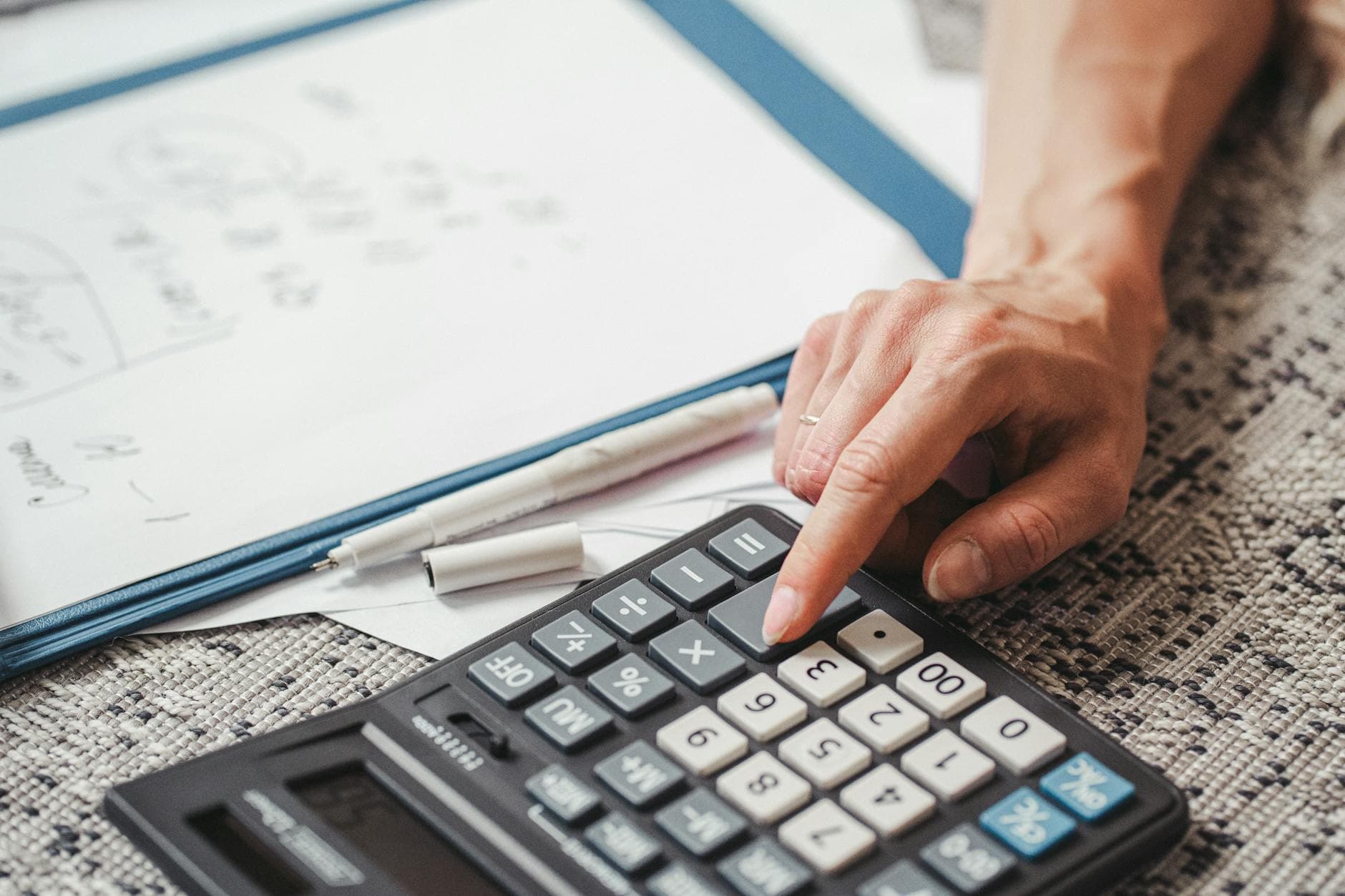 UK accountant reviewing tax documents for an Airbnb host in a modern home office