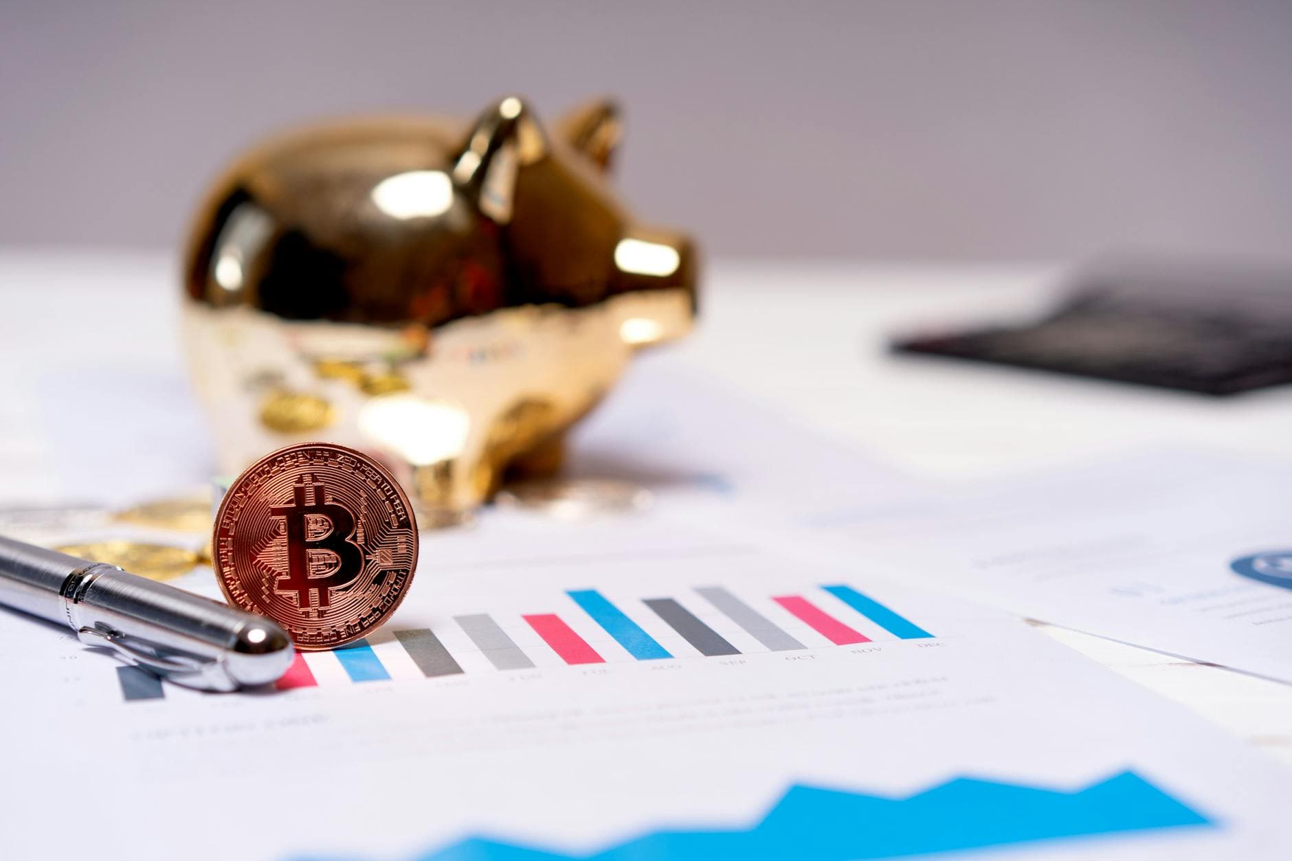 UK accountant reviewing cryptocurrency trading records on a laptop with Bitcoin and Ethereum price charts visible.