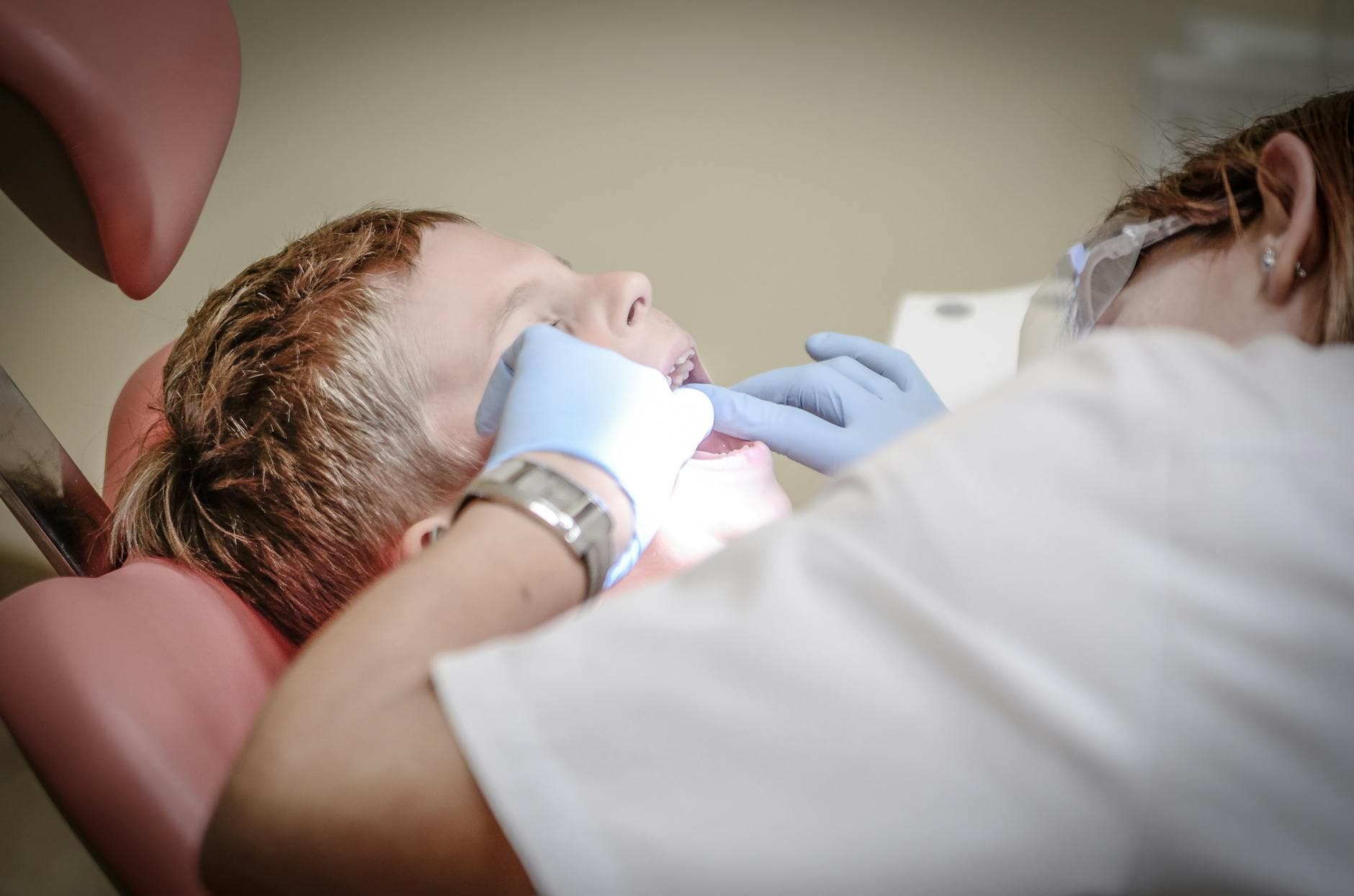A UK dentist in a modern dental practice reviewing financial paperwork with an ICAEW qualified accountant at a desk in a clean, bright office.