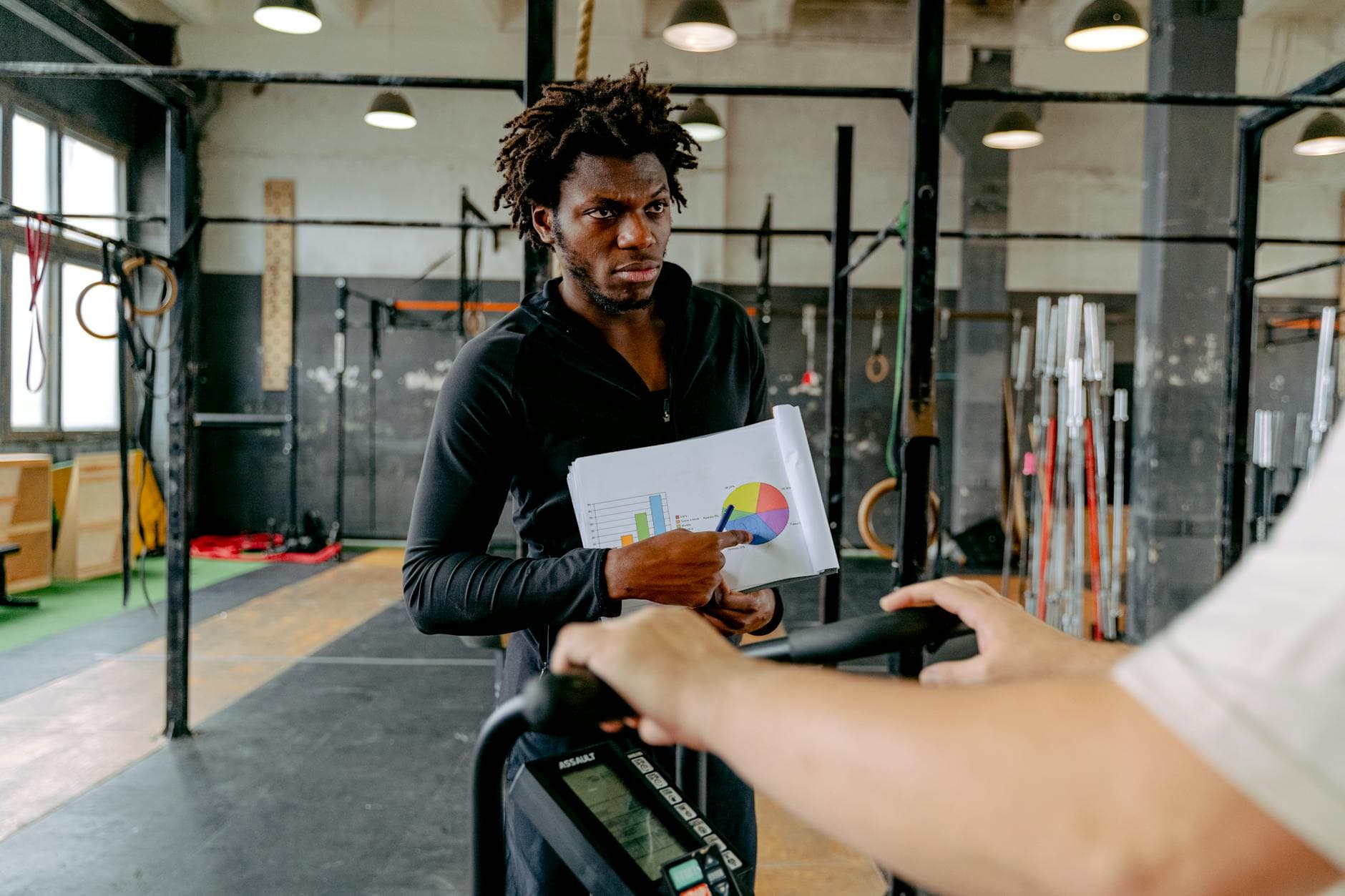 Personal trainer reviewing accounts with an ICAEW qualified accountant in a modern UK office