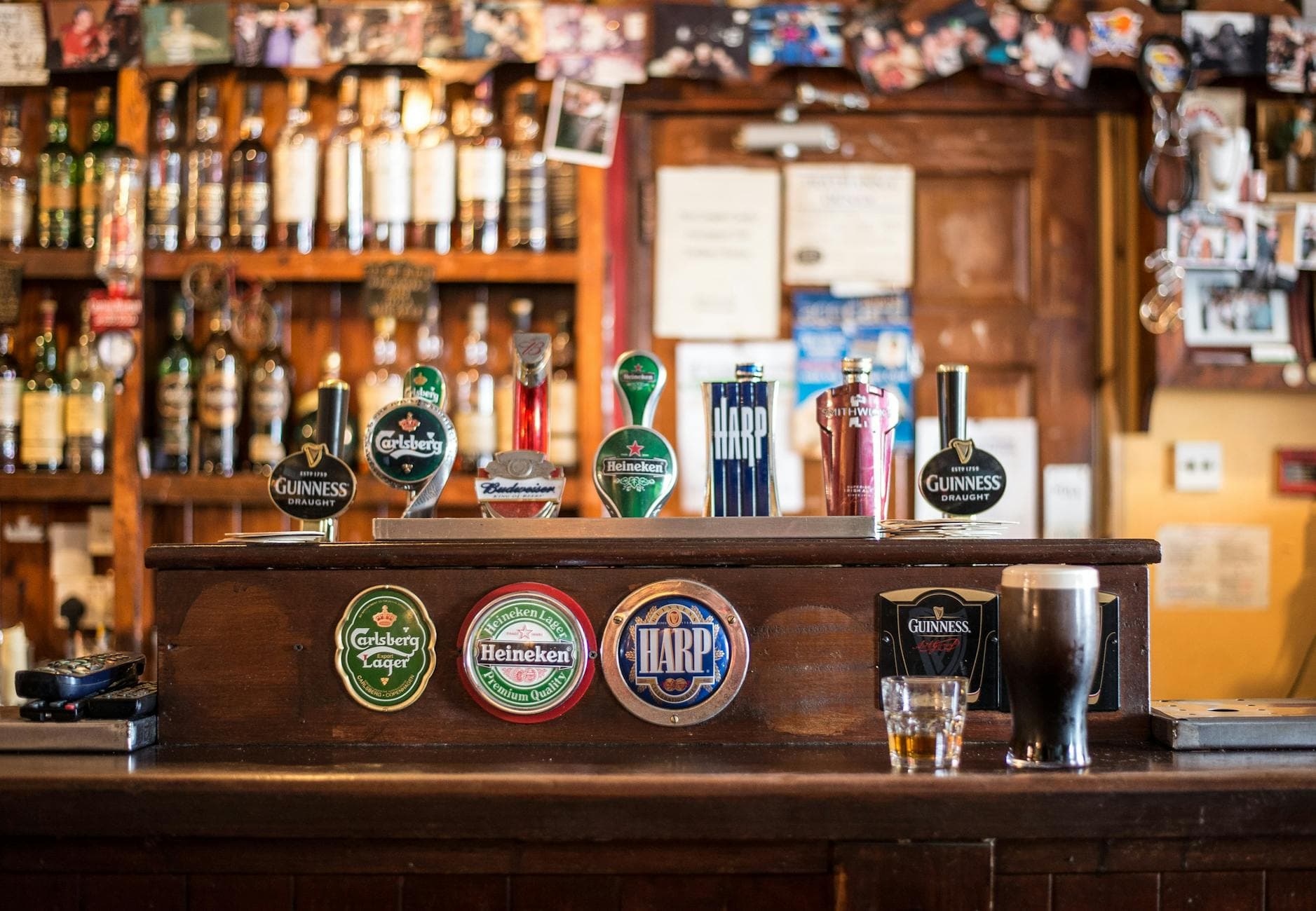 A modern pub interior in Manchester's Northern Quarter with bar staff serving drinks, representing a UK hospitality business