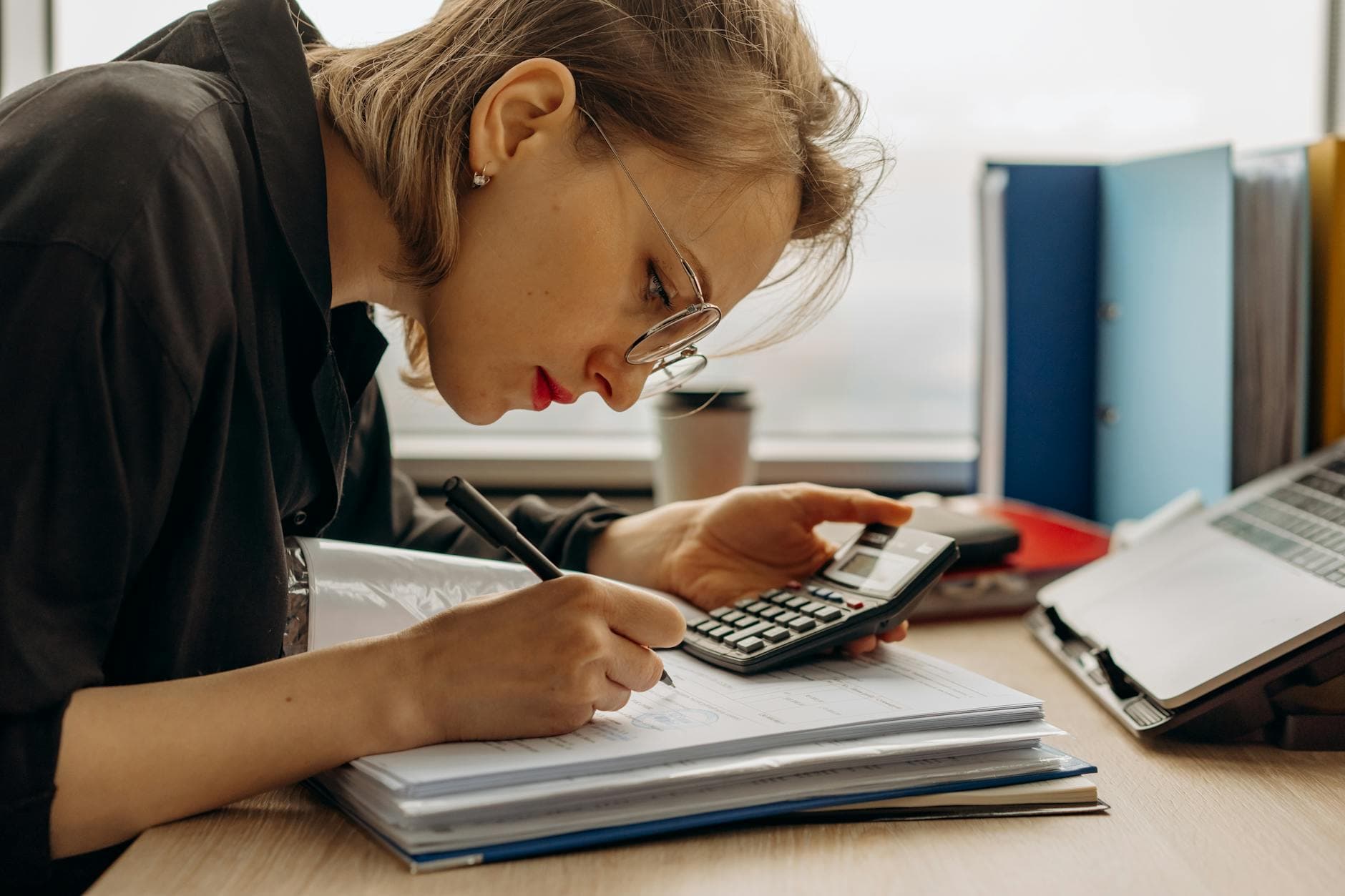 UK accountant and bookkeeper reviewing financial documents in a modern Manchester office