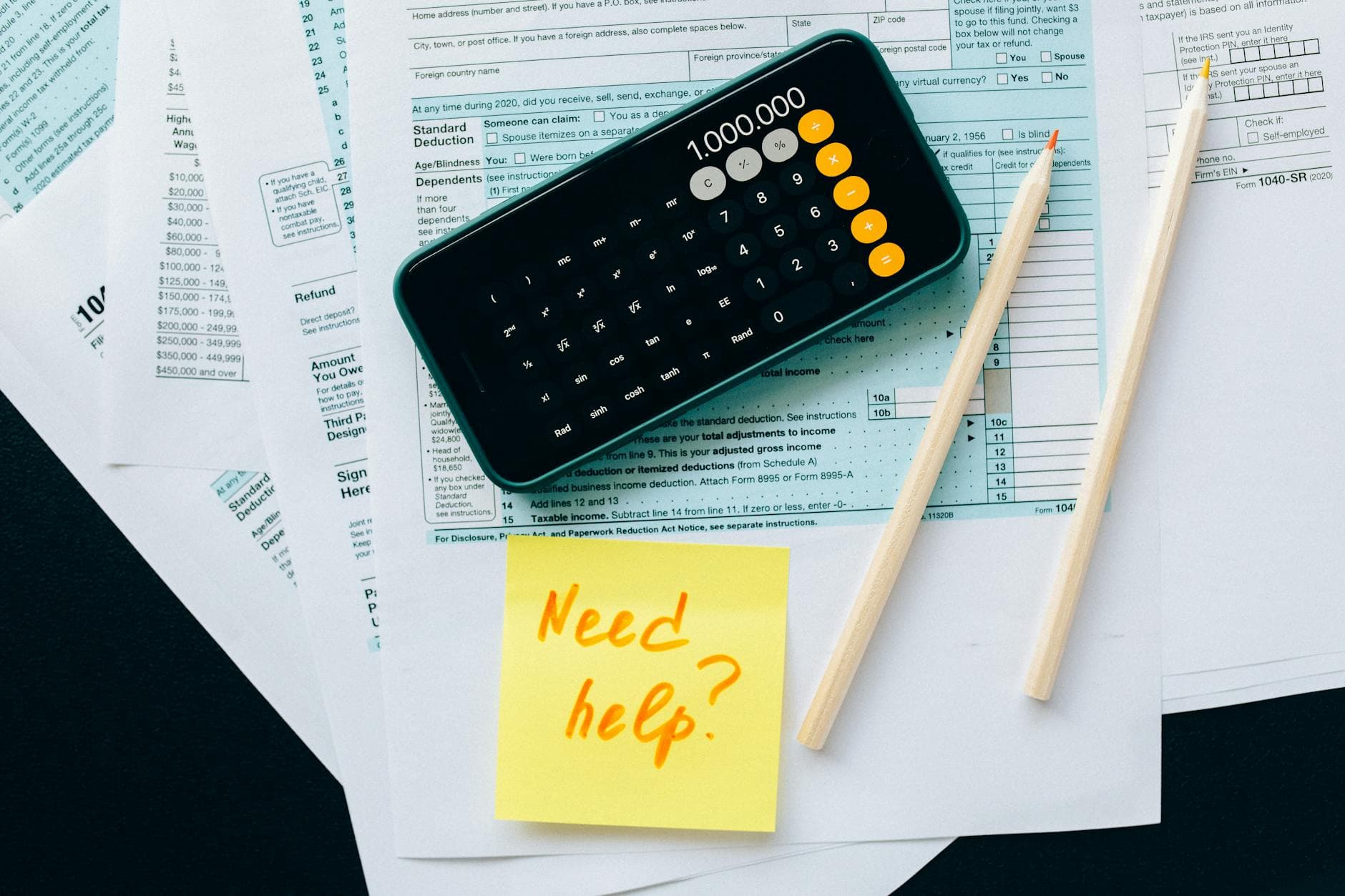 Senior ICAEW qualified accountant reviewing BADR paperwork with a business owner in a modern Manchester city centre office