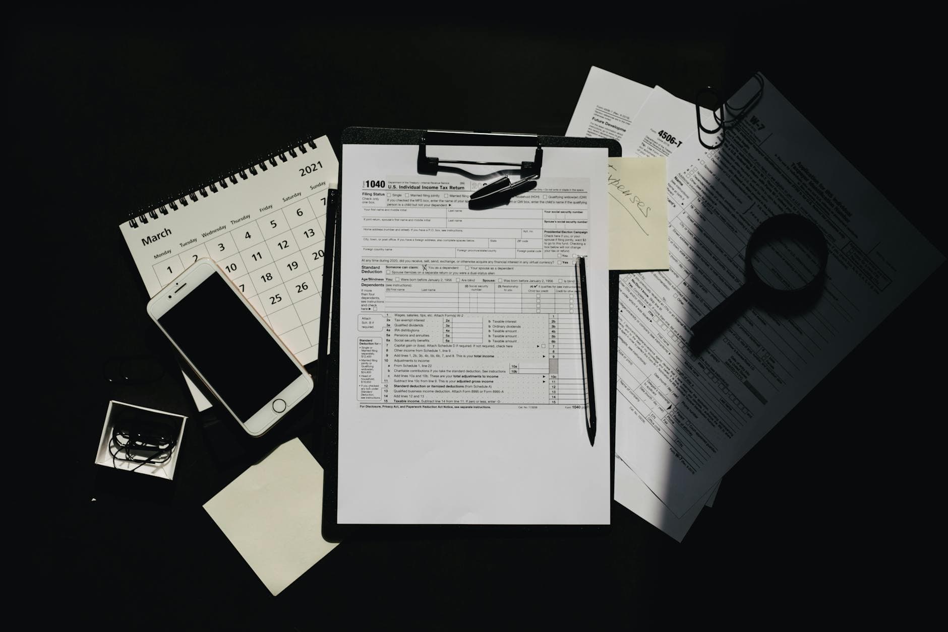 A UK business owner looking at a laptop showing a Companies House confirmation statement filing confirmation page, with a calendar in the background marking the due date.