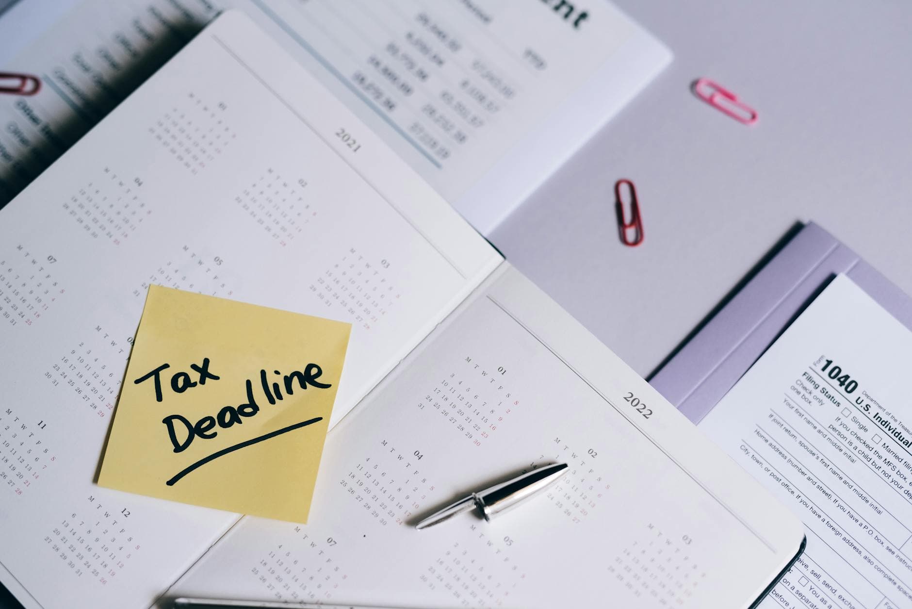 UK accountant reviewing a corporation tax return filing deadline for a company with a 31 March 2026 year end, showing a calendar and financial documents on a desk.