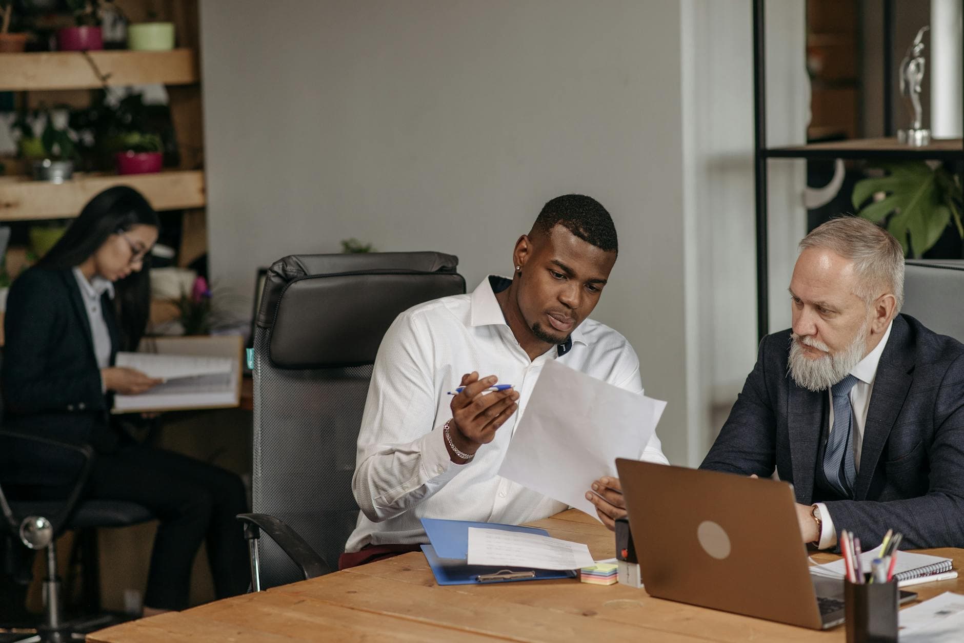 A company director signing off accounts at a desk in a modern UK office