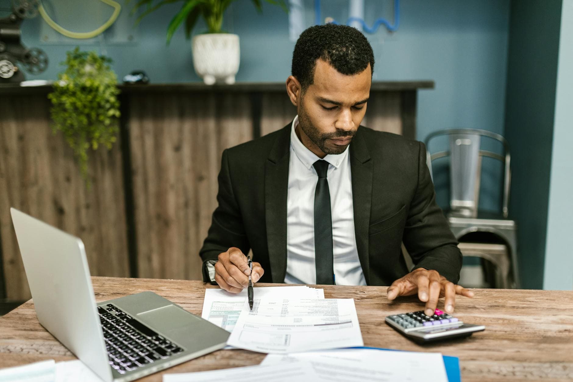 ICAEW qualified accountant reviewing HMRC penalty notice with client in a UK office