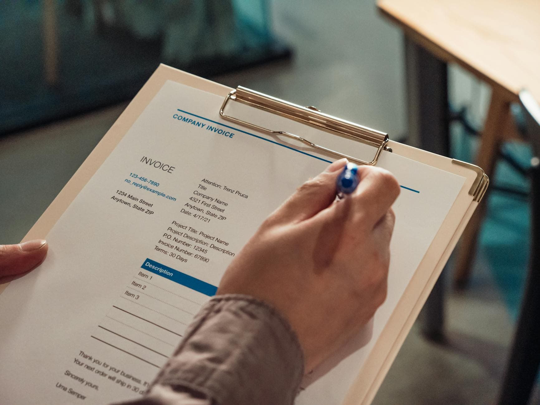 UK accountant reviewing limited company financial documents at a desk in a modern Manchester office