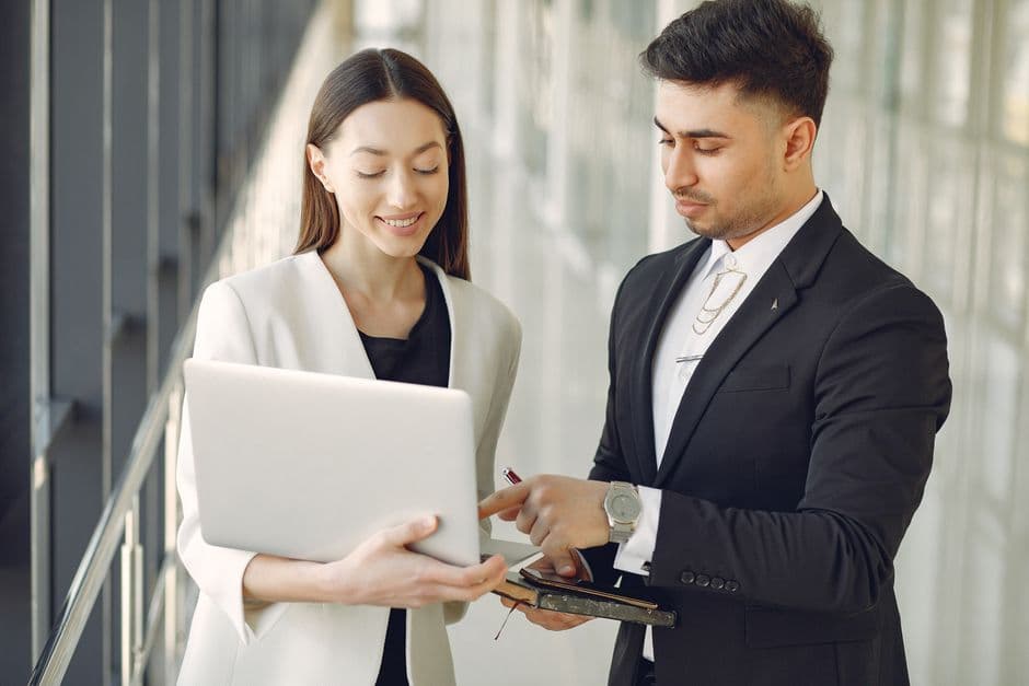 A UK accountant explaining LLP profit allocation and self assessment obligations to two members of a professional partnership