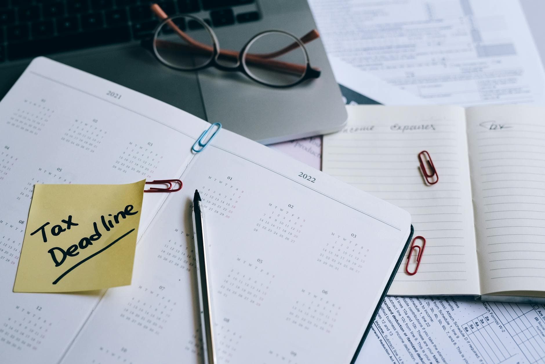 UK sole trader accountant reviewing self assessment paperwork at a desk in a Manchester office