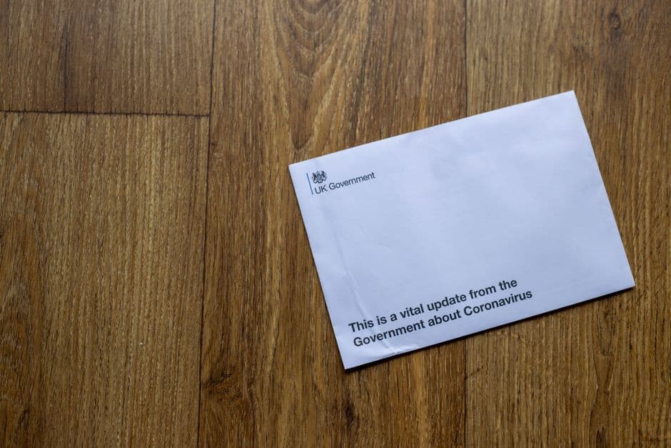 Person reviewing HMRC correspondence showing a Unique Taxpayer Reference number at a home office desk