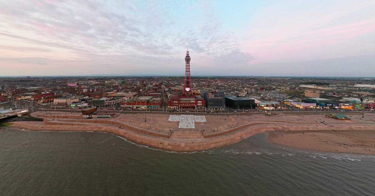 A breathtaking aerial view of Blackpool Tower and promenade during sunset, showcasing the vibrant cityscape.