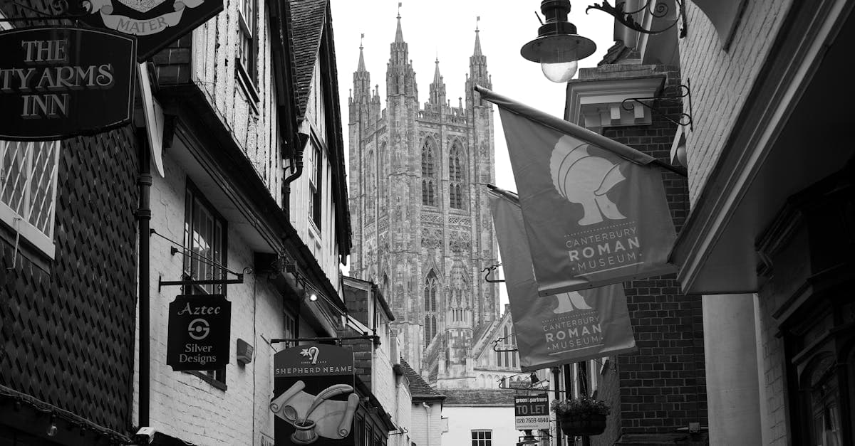 Black and white photograph of Canterbury Cathedral from a historic street in Canterbury, UK.