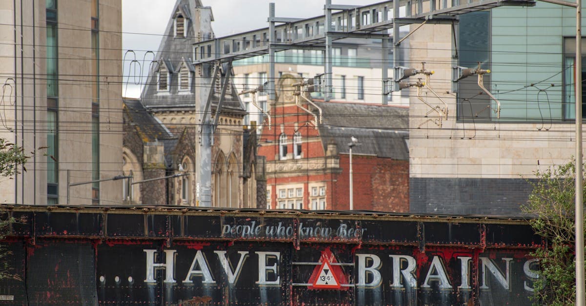 View of a historic railway bridge in Cardiff with urban buildings in the background.