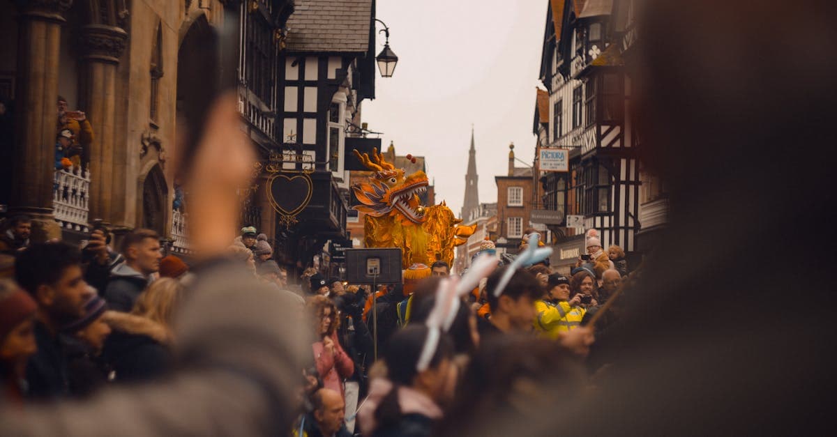 Vibrant festival parade with golden dragon in Chester, England.
