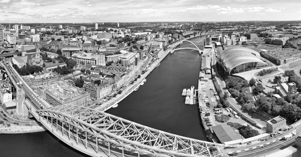 Black and white aerial view of Tyne Bridge and Quayside in Newcastle upon Tyne, highlighting architectural beauty.
