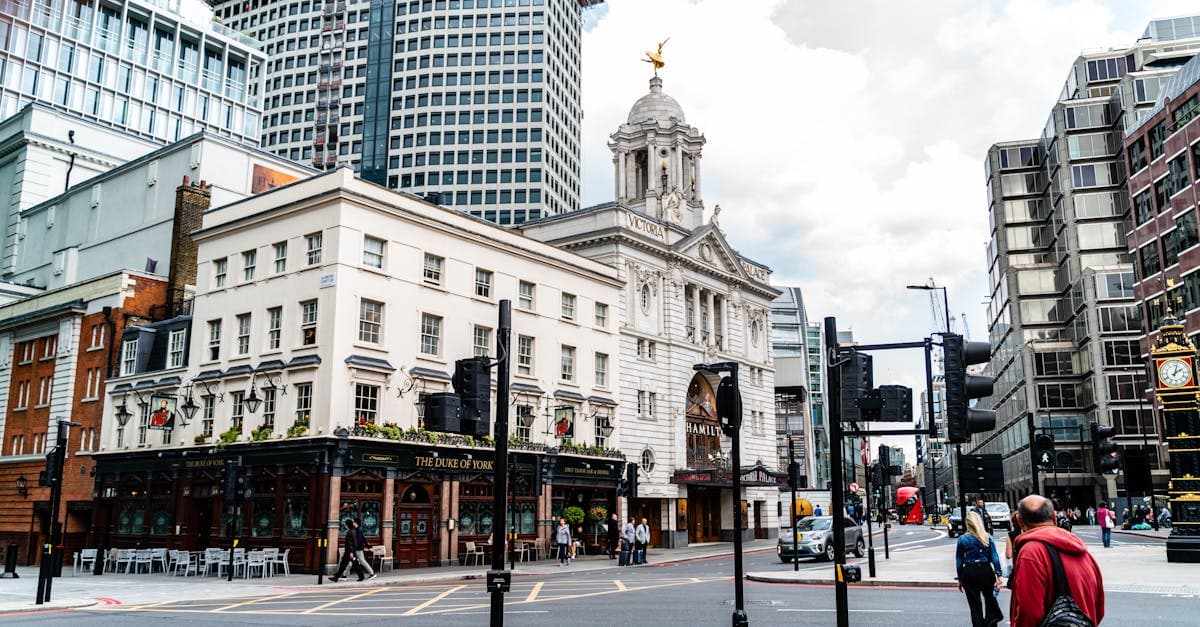 Street view of the iconic Victoria Palace Theatre and nearby buildings in London, England.