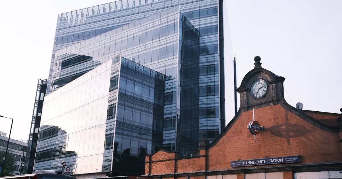 Hammersmith Station juxtaposed with modern glass building, London.