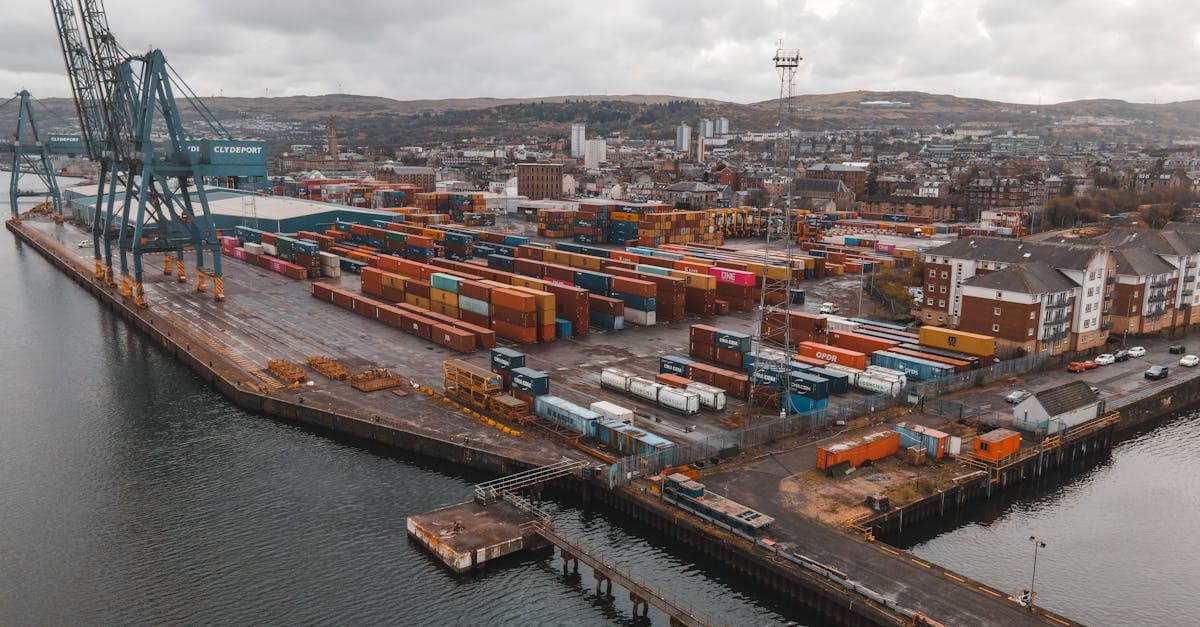 Aerial view of Greenock Harbor showcasing shipping containers and infrastructure in Scotland.