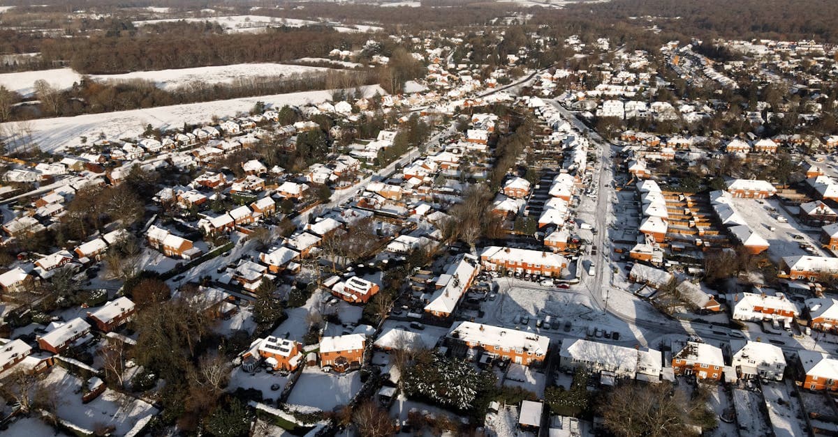 Aerial winter landscape of snow-covered houses in Leatherhead, Surrey, England.