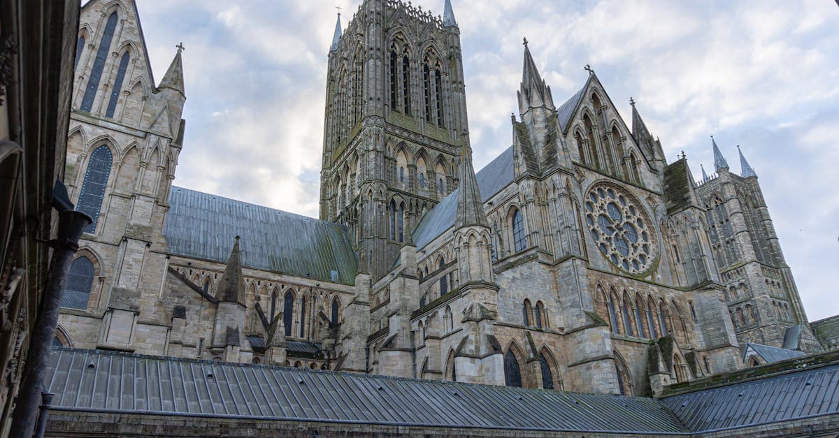 Lincoln Cathedral's stunning Gothic spires and intricate stonework against a serene sky.