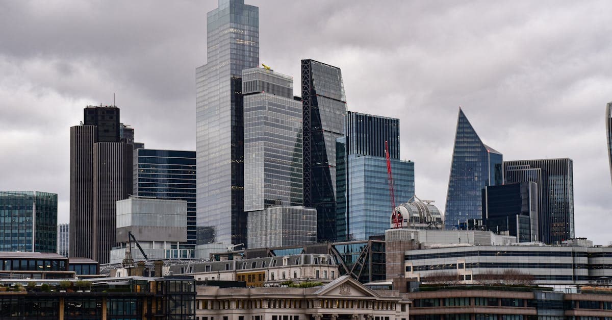 A dramatic view of London's city skyline featuring iconic modern skyscrapers.