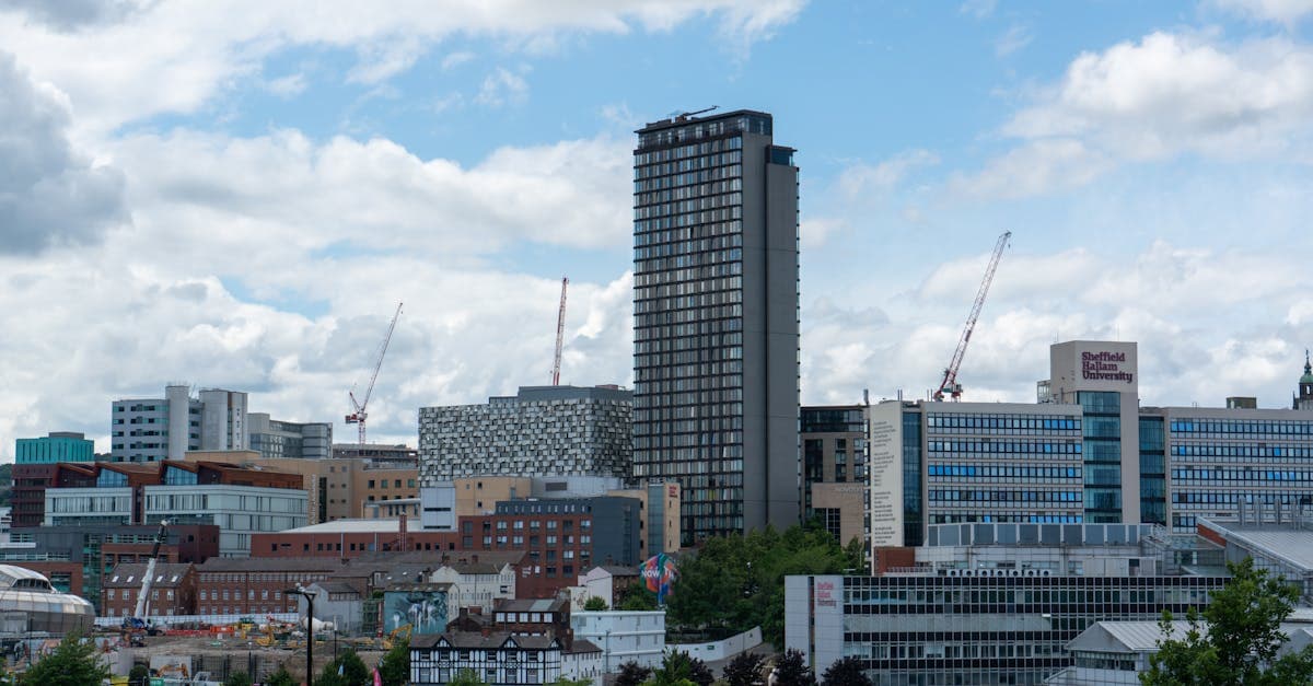 Urban skyline of Sheffield featuring modern buildings and cloudy skies under daylight.