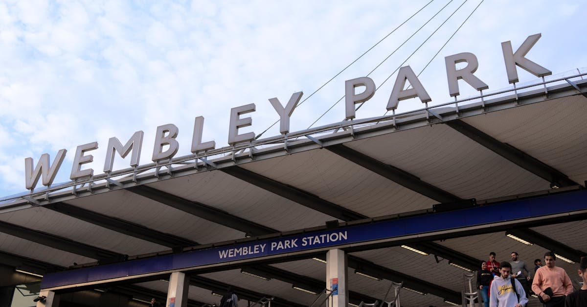 Crowd at Wembley Park Station entrance, a bustling urban transit hub in London.