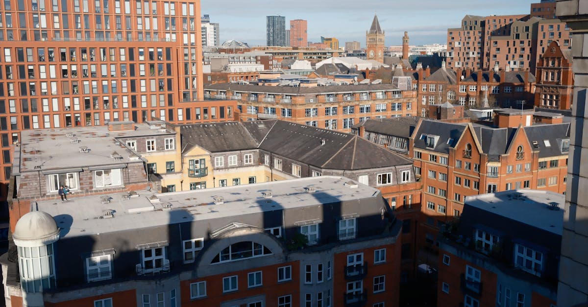 View of Manchester skyline showcasing distinctive red brick buildings under blue skies.