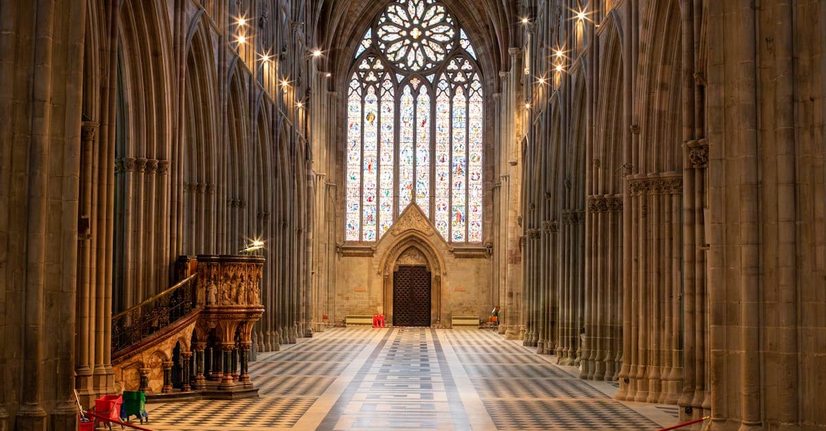 Explore the magnificent interior view of Worcester Cathedral with its towering arches and stained glass windows.