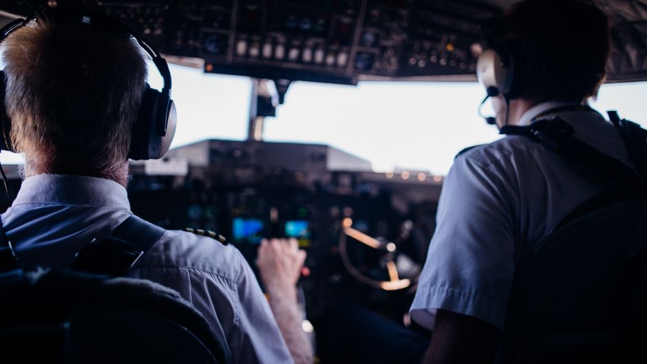 Flight deck instrument panel and throttle quadrant of an airliner in cruise