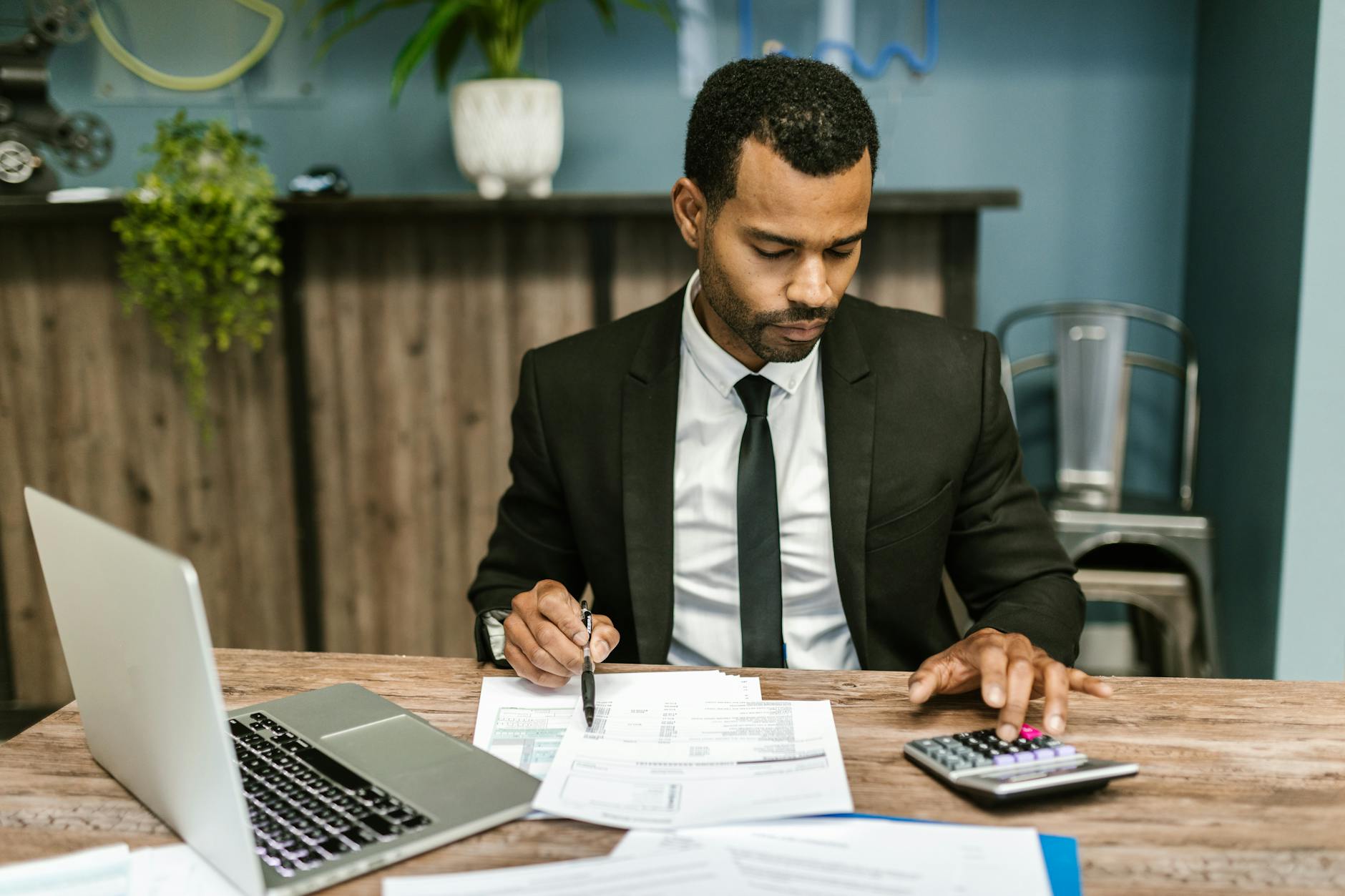 Accountant reviewing HMRC penalty notice with client in a UK office