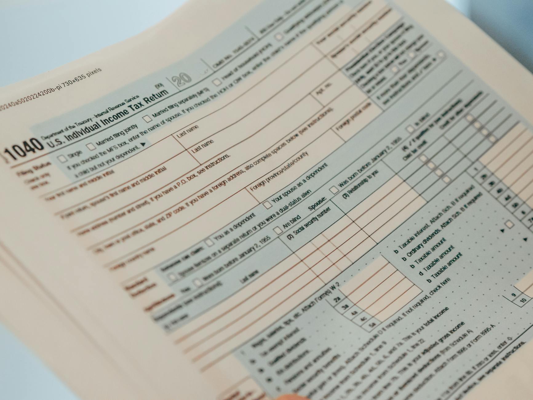UK accountant reviewing R&D tax credit claim documents on a desk with a laptop and calculator