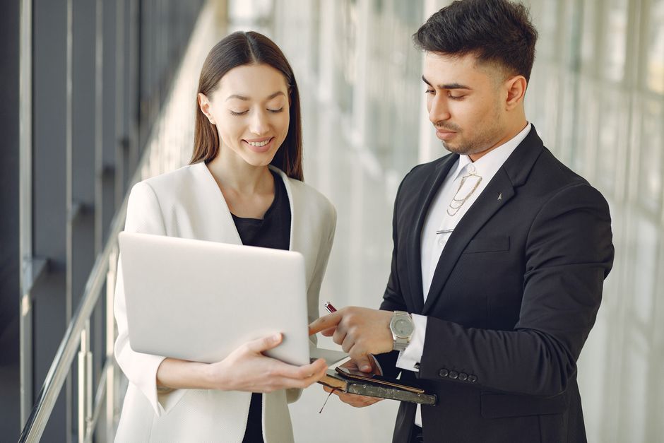 A UK accountant explaining LLP profit allocation and self assessment obligations to two members of a professional partnership
