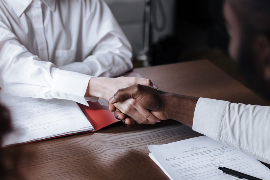 Business owner comparing exit routes and capital gains tax figures on paper