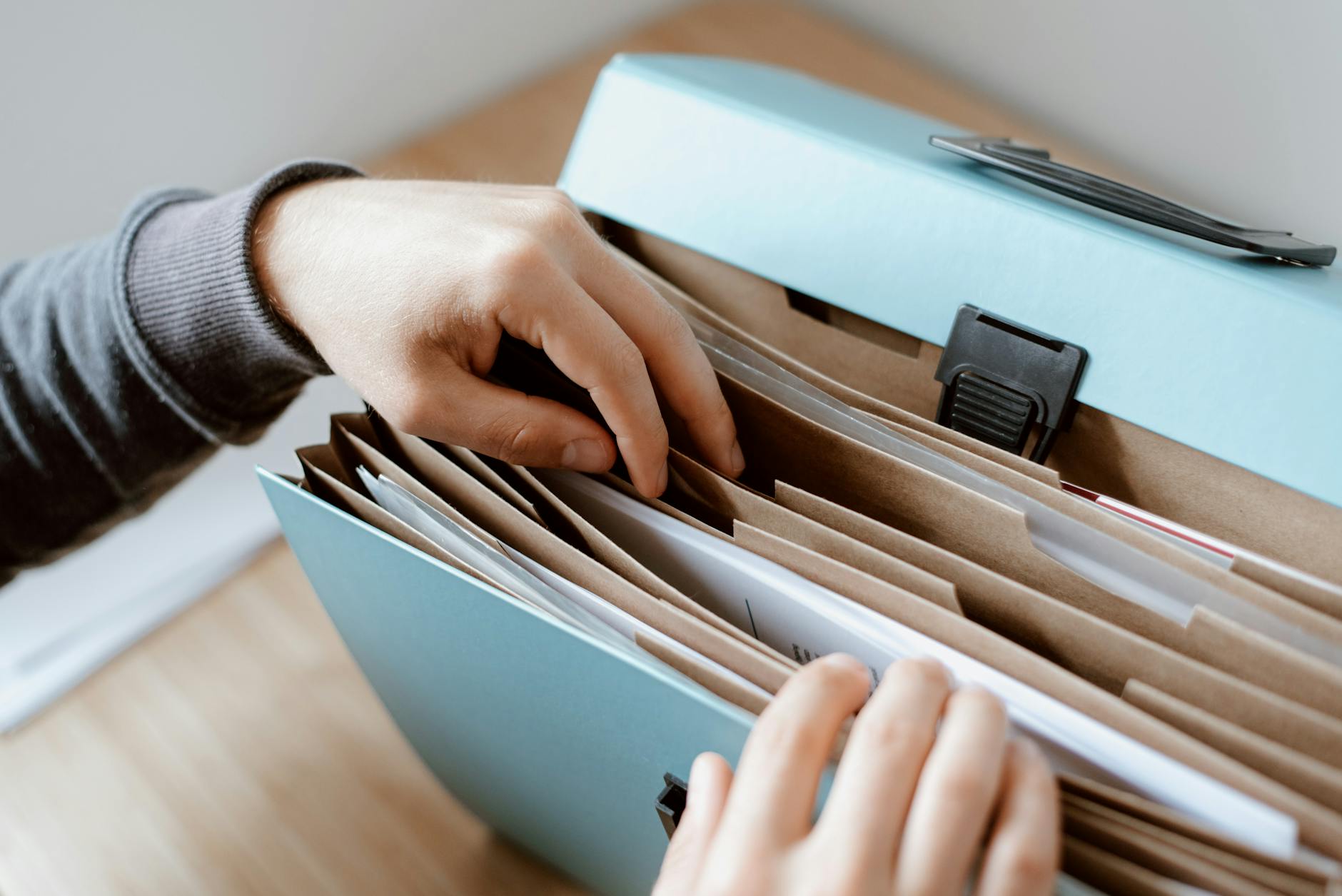 Two business owners reviewing financial reports with their accountant in a modern Manchester office